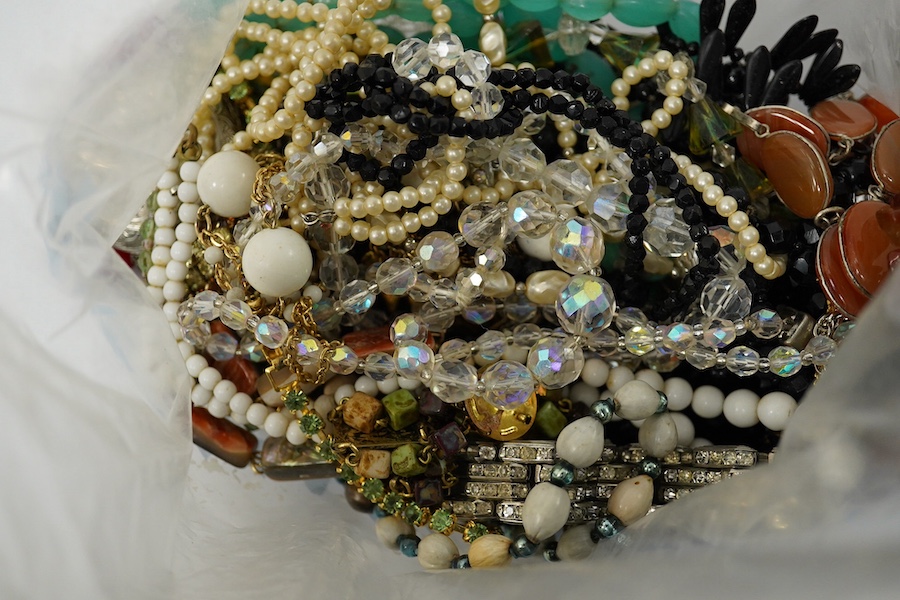 Four large bags of assorted costume jewellery including, brooches, necklaces, bangles, etc. Condition - poor to fair to good